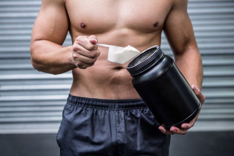 Cum sa aleg cea mai eficienta creatina (sportiv care isi prepara un shake proteic, cupa cu creatina, recipient negru)